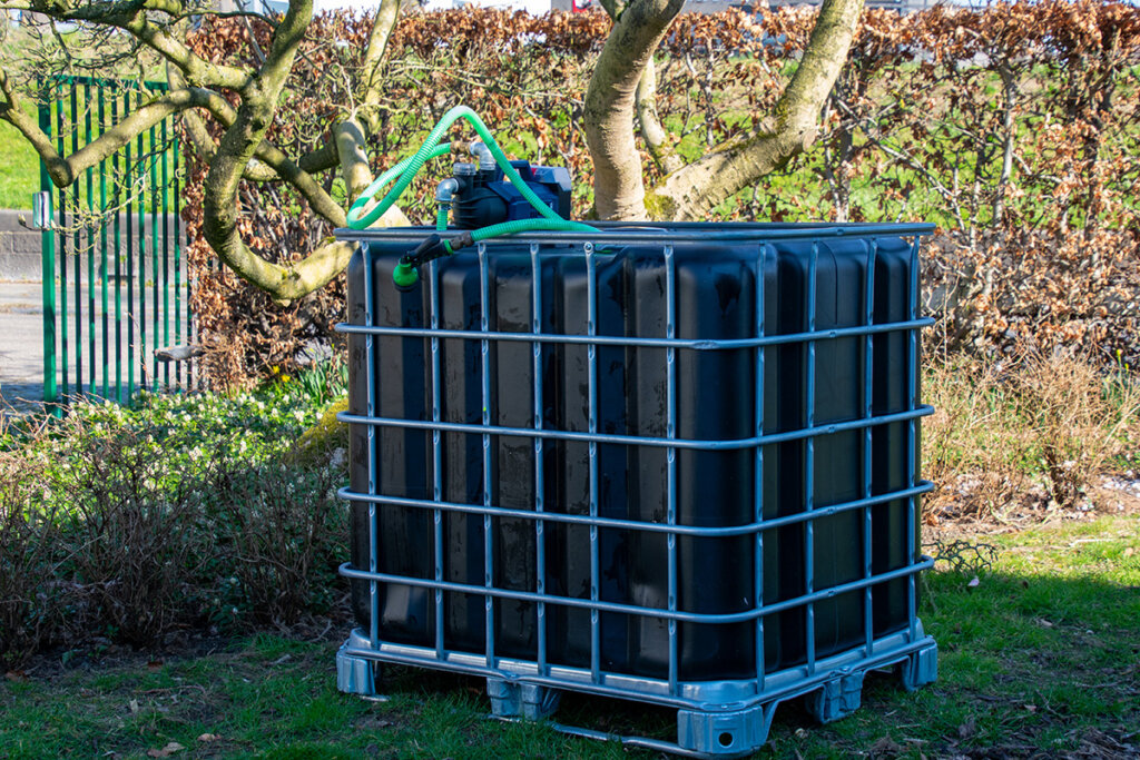 IBC container ZWART op metalen of kunststof pallet - met accu pomp - vernieuwd